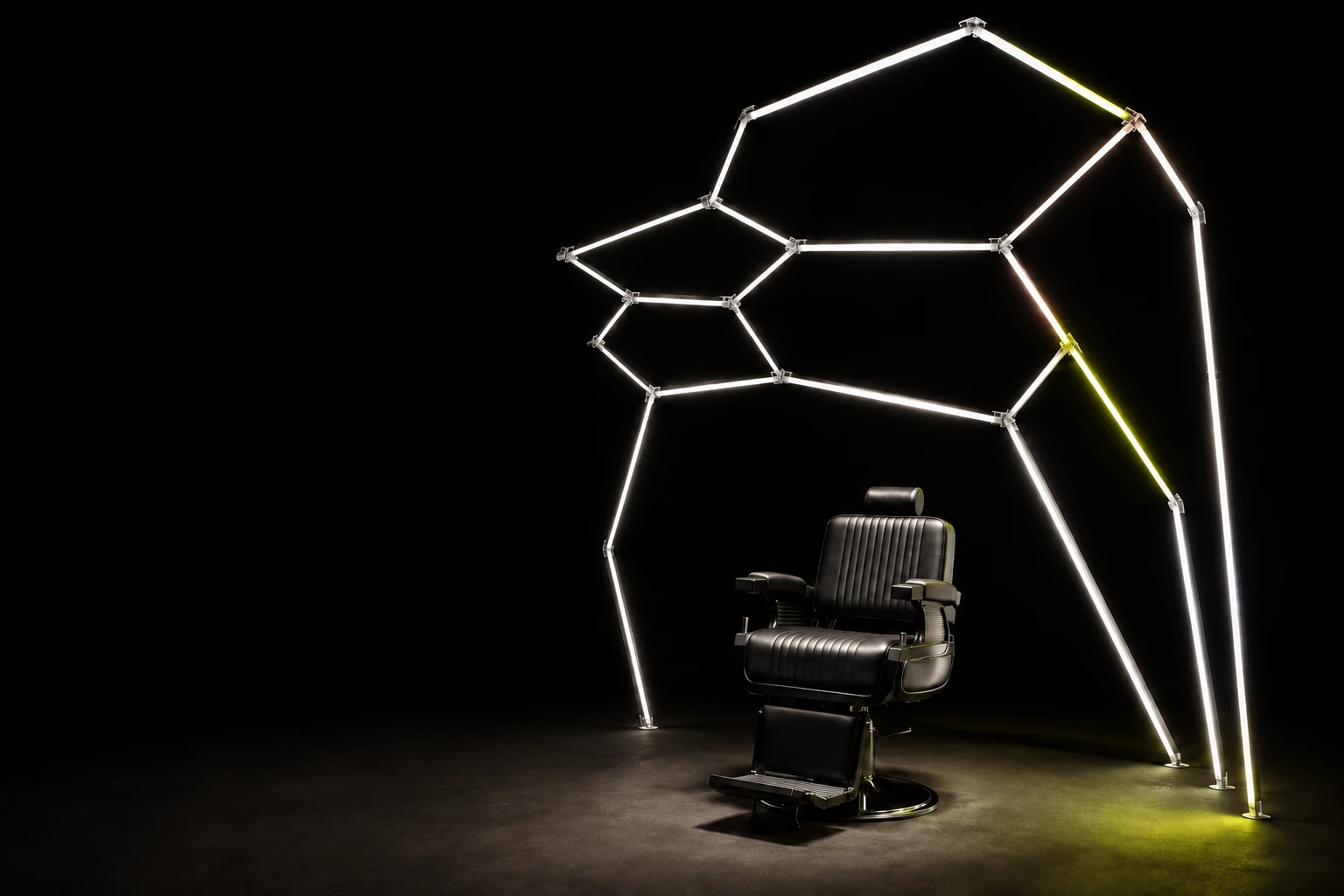 A barber chair beneath sculptural geometric lights in a dark studio